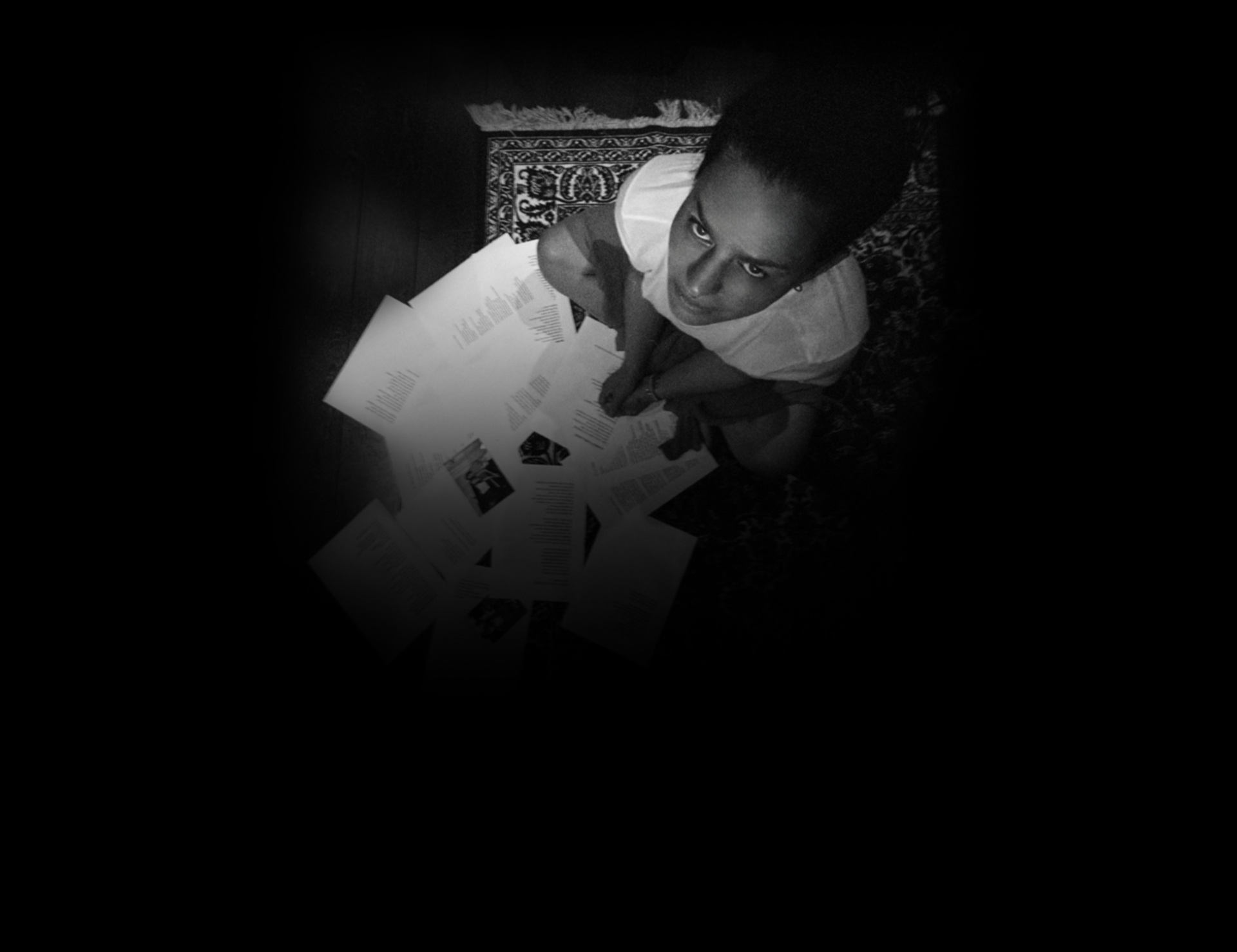 Ximena Muñoz surrounded by lyrics and photographs while creating La casa de las sombras